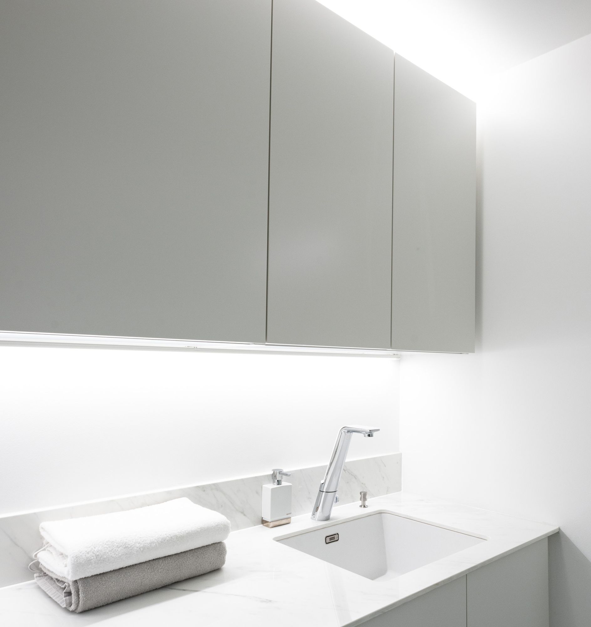 LED strip in the corner to bring light to the level, LED strip on top of the cabinets to create indirect light. Ledstore.fi